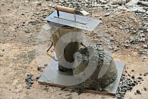 The slump test equipment. Wet concrete was compacted for the slump test.